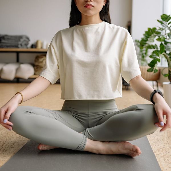 Person sitting in a calm meditative yoga pose with eyes closed.